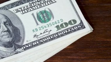 Kahverengi ahşap masa arka planında dolar parası