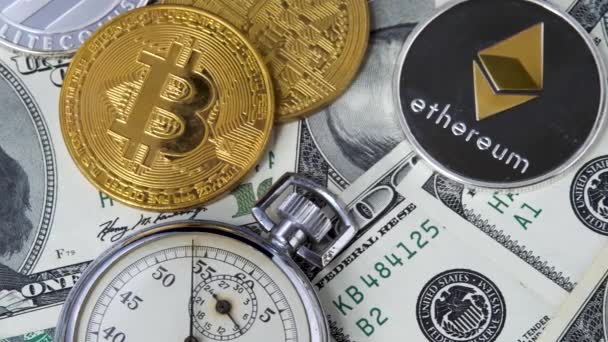 Bitcoin BTC and Ethereum ETH coins with stopwatch lies on dollars bills — Stock Video