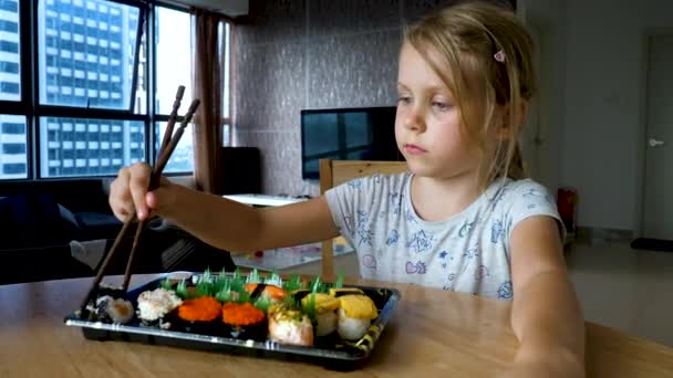 Cute Kid take japanese variation sushi food — Stock Video