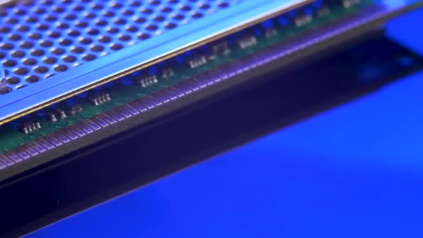 Memory module for PC with contact pins on blue light mirror surface — Stock Video