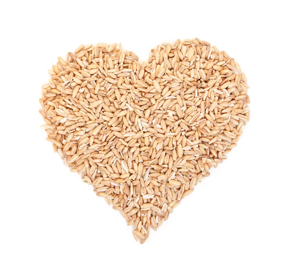 Oat grains laid out in the shape of heart isolated on white. Top Stock Image