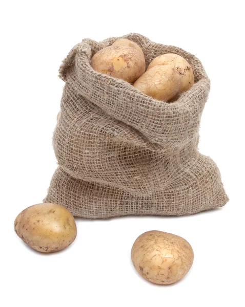 Potato tubers in a sack isolated on white Royalty Free Stock Images