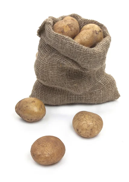Potato tubers in a sack isolated on white Stock Photo