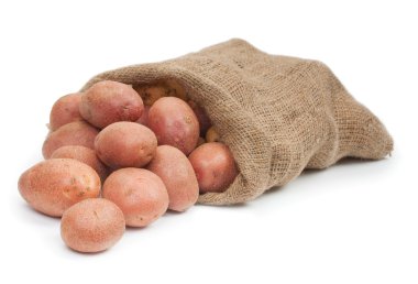 Kırmızı patates yumrular üzerinde beyaz izole bir çuvalın içinde