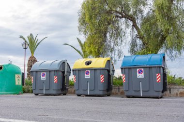İspanya 'daki renk kodlu atık ve geri dönüşüm kutuları ev atıklarını ayırmaya yardımcı oluyor. Sarı kapaklar plastik ve teneke kutular için, yeşiller cam için ve gri kutular genel geri dönüşümsüz atık için..