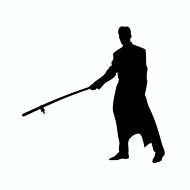 Uzun paltolu bir insan, kararlı bir duruşla asasını tutarak özgüvenle ayakta durur. Arkaplan düz, figürün hareketini ve gücünü vurguluyor..