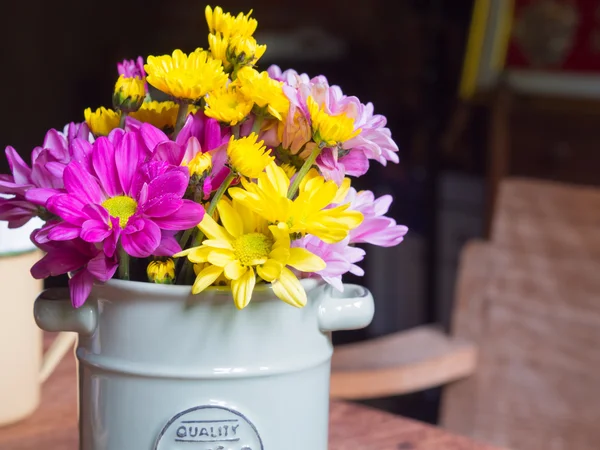 Jarrón con hierro y flores, estilo vintage sobre la mesa en las cafeterías . — Foto de Stock