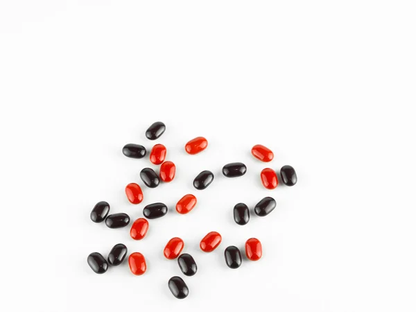 Red and black Vitamin Pills isolated on white background. — Stock Photo, Image