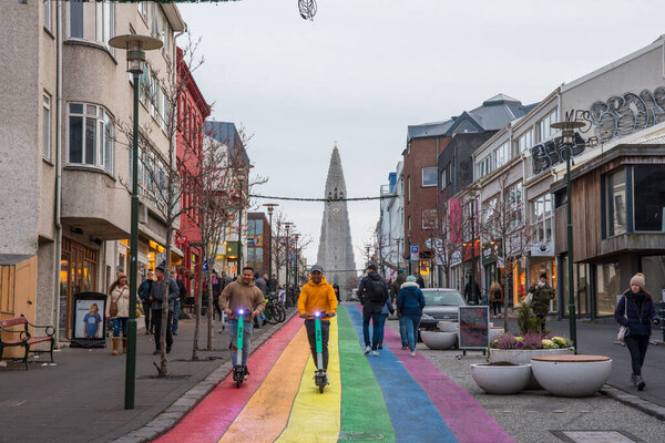 Reykjavik Iceland - November 2. 2019: People walking on the rainbow painted Skolavordustigur street