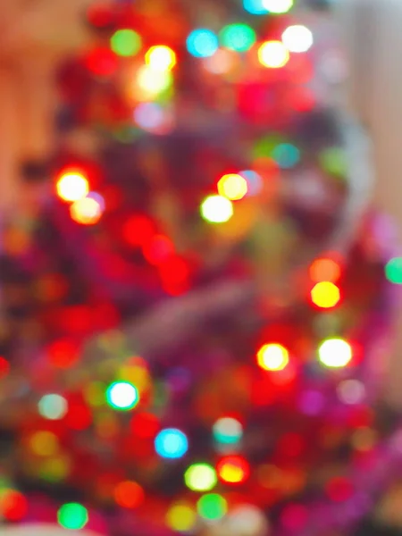 Christmas theme background. Blurred image of Christmas tree garland. Abstract background with bokeh. Soft focus.