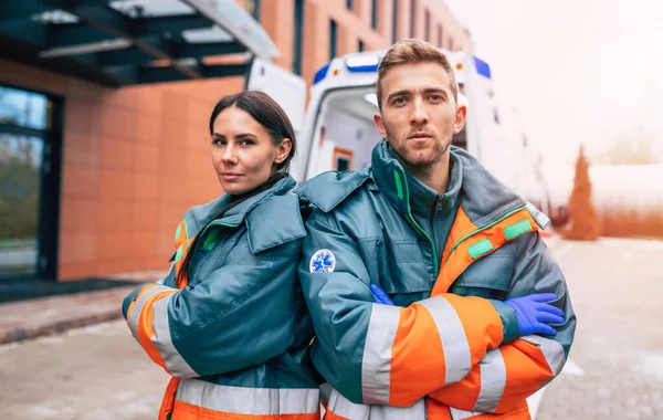 Two Confident Young Doctors Looking Camera Ambulance Hospital Background — Stock Photo, Image