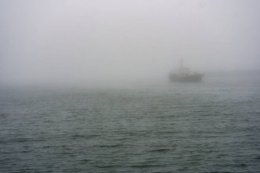 Ghost Ship Silhouette on Choppy Baltic Sea in Heavy Fog
