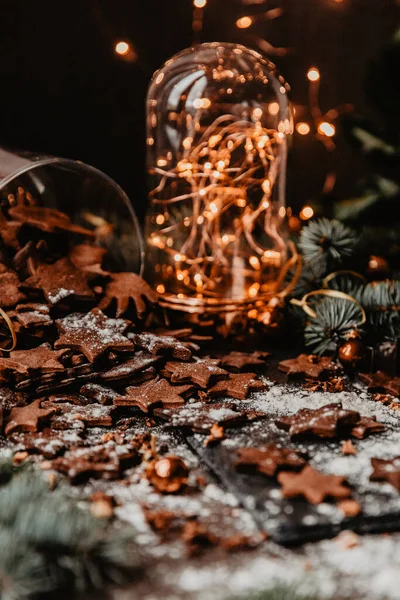 Geleneksel zencefilli kurabiyeler, arka planda bokeh lambalı. Dikey fotoğraf, Tatil sezonu etkinliği.