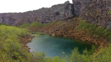 Kuzey İzlanda 'daki Asbyrgi Buzul Kanyonu. Asbyrgiskogur Ormanı ve Botnstjorn Gölü dikey dağ duvarı ile çevrilidir..