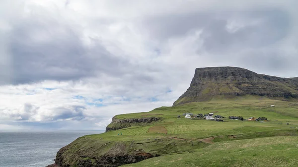 Dramatic landscape scenery on Faroe Islands with waves hitting the shore. The nature of the Faroe Islands in the north Atlantic