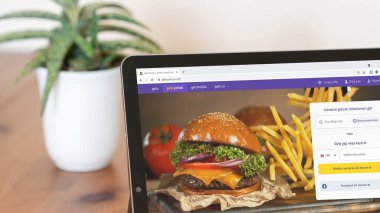 İstanbul, Türkiye - Ağustos 2021: Türk Getir web sitesinin illüstrasyon editörü. Getir logosu tablet ekranda görünüyor. Getir market ürünleri için talep üzerine bir ultra hızlı teslimat servisidir..