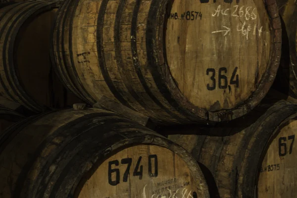 Old wood barrels with old brandy close up