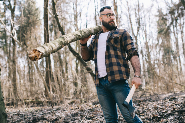 Bearded lumberjack in the wood