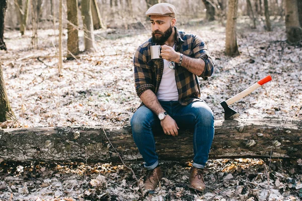 Bearded lumberjack in the wood — Stock Photo, Image