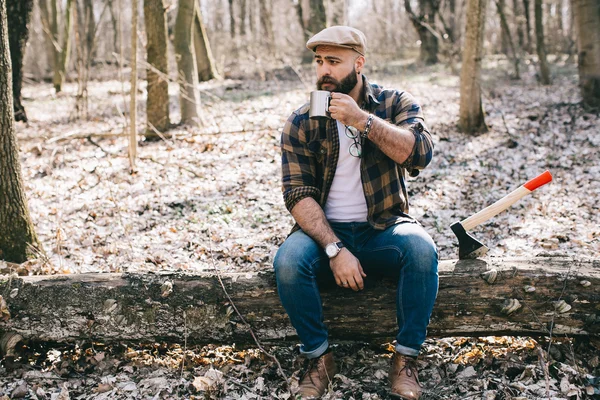 Bearded lumberjack in the wood — Stock Photo, Image