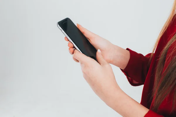 Girl in red shirt using smartphone — Stock Photo, Image