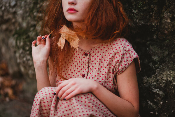 Beautiful young redhead girl in castle park