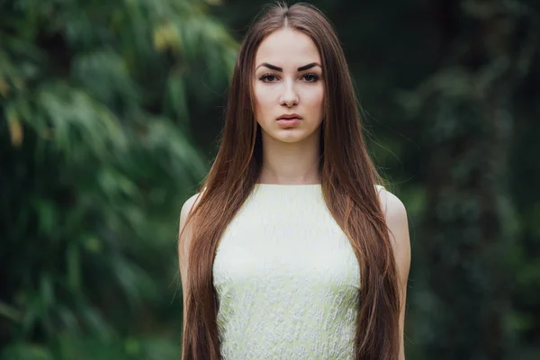 Beautiful girl in green tress — Stock Photo, Image