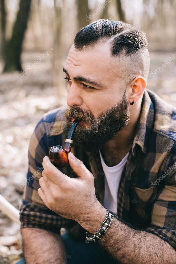 Bearded man smoking pipe Stock Photo by ©anatoliycherkas 121974114