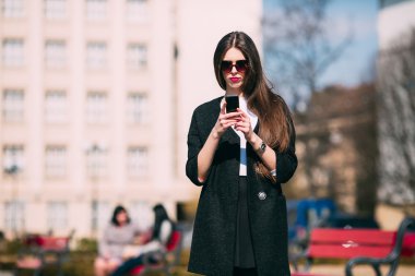 Telefonu olan genç bir kadın.