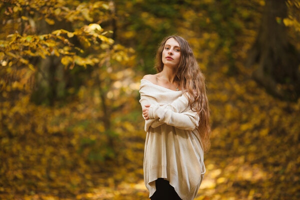 Beautiful young woman with long hair in woods