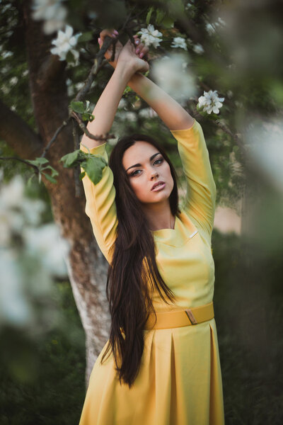 Beautiful young woman in yellow dress outdoors