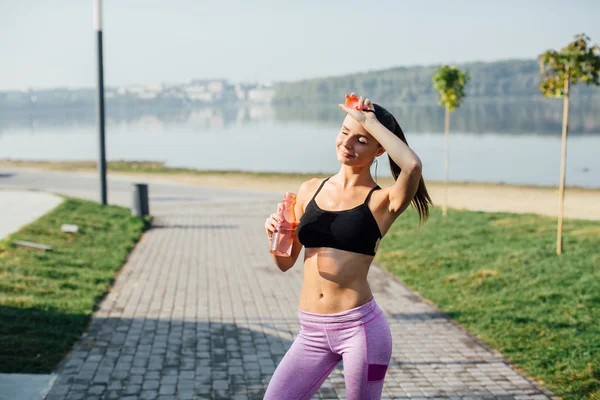 Mujer joven bebiendo agua — Foto de Stock