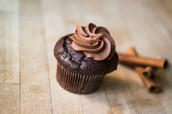 Chocolate cupcake with cinnamon sticks.