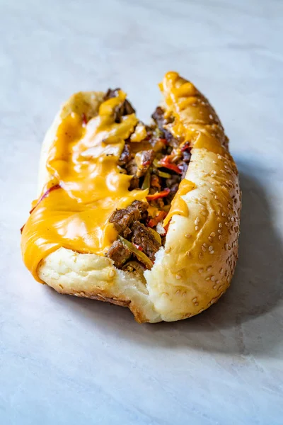 Philly Cheese Steak Sandwich with Melted Cheddar Cheese. Ready to Eat Fast Food.