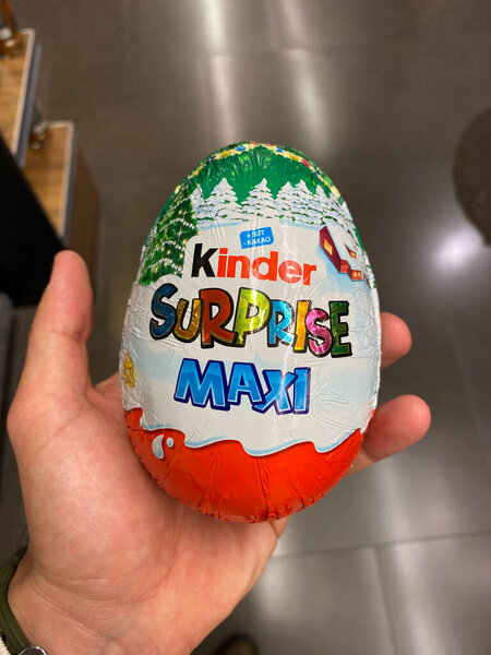 ISTANBUL, TURKEY - MAY 11 2019:  Kinder Surprise Maxi Holding in Hand at Supermarket for Sale. Ready to Eat.