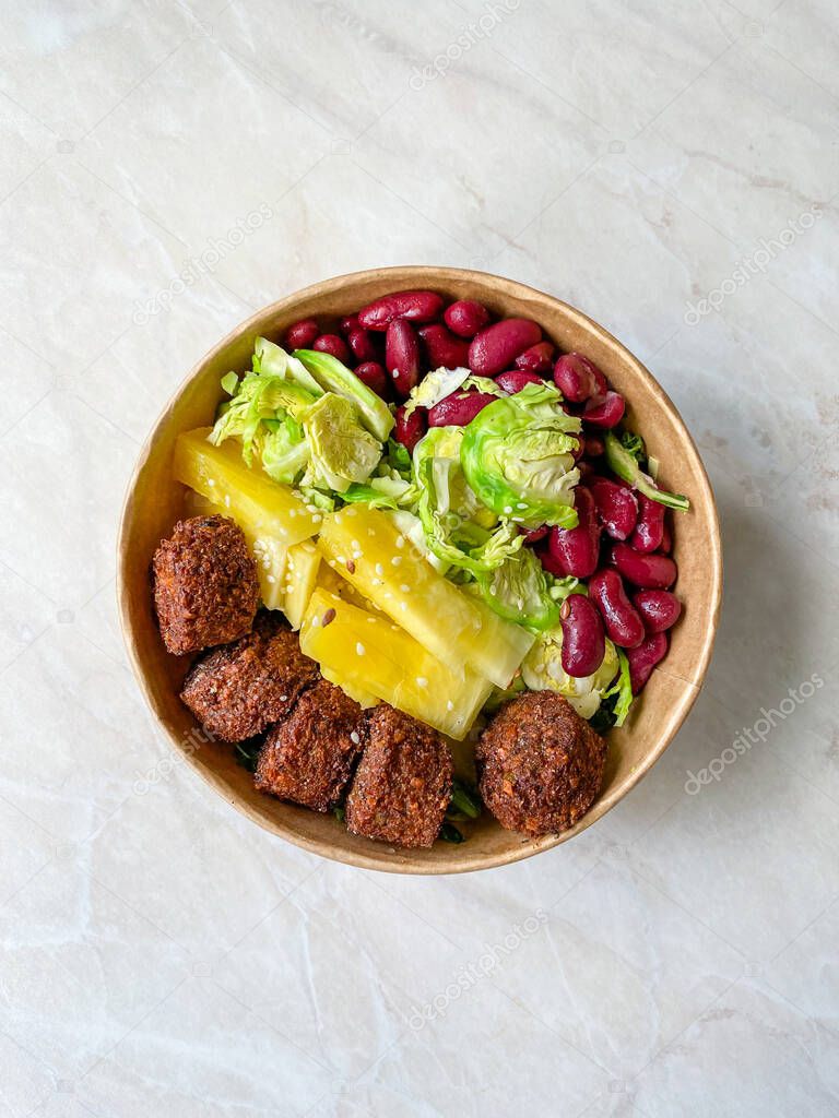 Healthy Food Bowl with Falafel, Pineapple, Mexican Red Kidney Beans and Brussel Sprouts in Plastic Bowl / Box or Container Package. Ready to Eat.