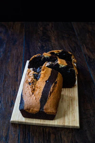 Homemade Whole Sliced Zebra Cake with Chocolate on Wooden Board. Ready to Eat.