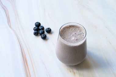 Mermer yüzeyde taze yaban mersinli ev yapımı meyve püresi. İçmeye hazır..