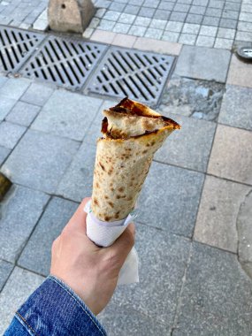 Traditional Turkish Street Food Lahmacun Holding in Hand. Ready to Eat. clipart