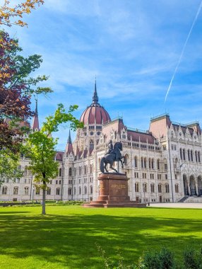 Budapest, Hungary, May 01, 2025. Budapest parliament palace with ornate gothic revival facade and central dome viewed from park Hungary. High quality photograph.
