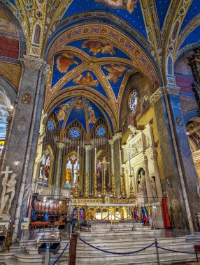 Rome, Italy, May 01, 2025. Gothic church interior showing altar area with blue star vaulted ceiling, stained glass and religious decorations in Rome, Italy. High quality photograph.