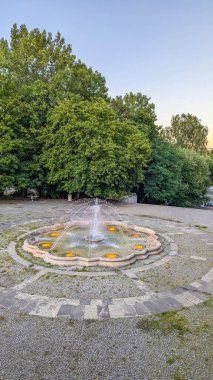 Stone mosaic compass rose with colorful decorative pattern in park pavement in Warsaw Poland showing ornamental ground design and geometric art on summer day. High quality photograph