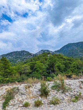 Scenic mountain valley with distant peaks and white rocky terrain under blue sky with clouds near Antalya Turkey. High quality photograph