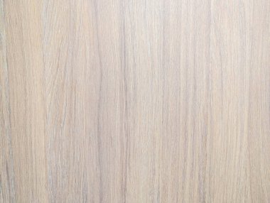 Natural wood texture panel with visible grain pattern and knots on light beige wooden surface background. High quality photograph.