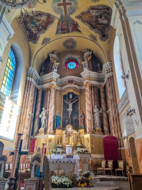 Grodno, Belarus, May 01, 2025. Elaborate baroque church altar featuring golden ornamental details painted ceiling frescoes blue stained glass and classical religious architectural elements. High quality photograph