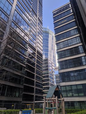 Warsaw, Poland, May 01, 2025. Towering contemporary glass and steel office skyscrapers reflecting blue sky in modern Warsaw business financial district. High quality photograph