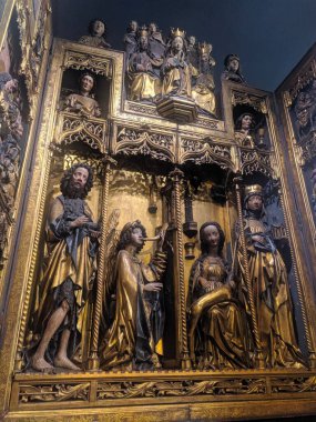 Warsaw, Poland, May 01, 2025. Ornate golden baroque altar featuring intricate religious sculptures and detailed craftsmanship inside historic Warsaw church interior. High quality photograph