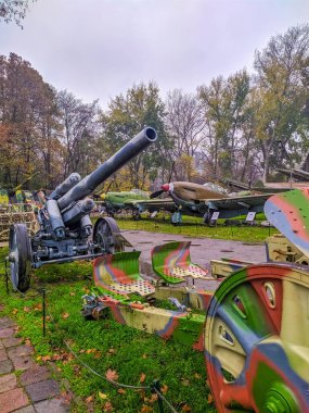 Warsaw, Poland, May 01, 2025. Artillery pieces and military vehicles exhibition with colorful information panels at Warsaw Polish Army Museum outdoor educational display area. High quality photograph