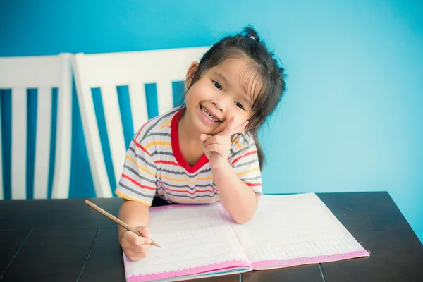 Asian young girl children happy doing her homework people, family concept Royalty Free Stock Images