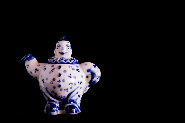 Porcelain figurine. A little cute thing on black background — Stock Photo, Image